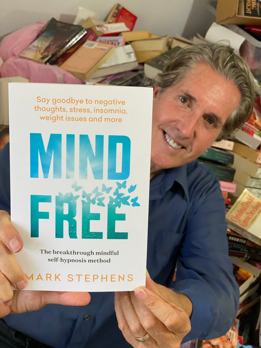 Mark holding his book Mind Free