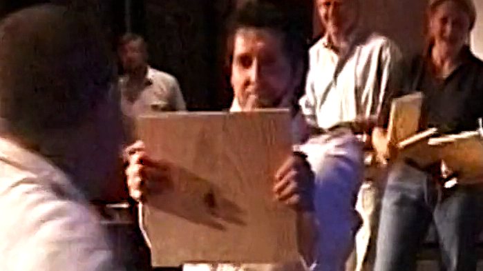 A participant holding up a board for the board-breaking exercise